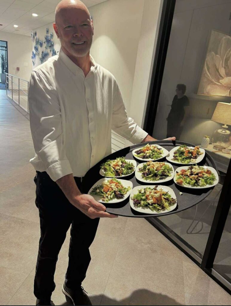 John 316 Center Taste Around the Lake 2025 server with tray of gourmet salads