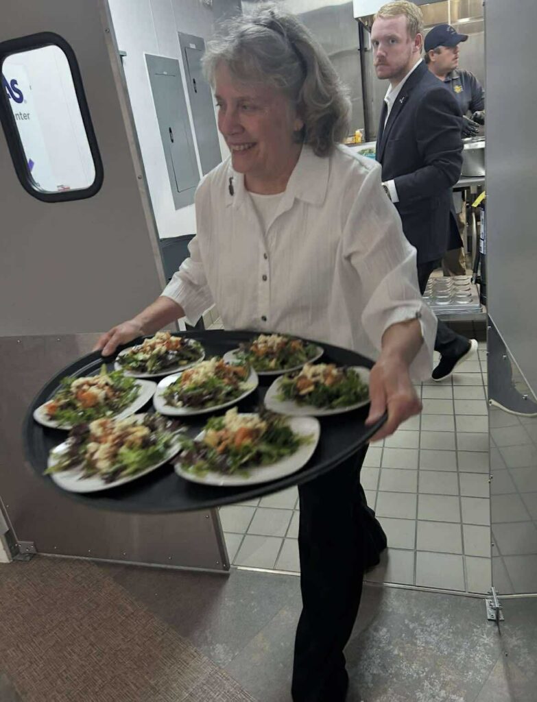 John 316 Center Taste Around the Lake 2025 server with tray of gourmet salads