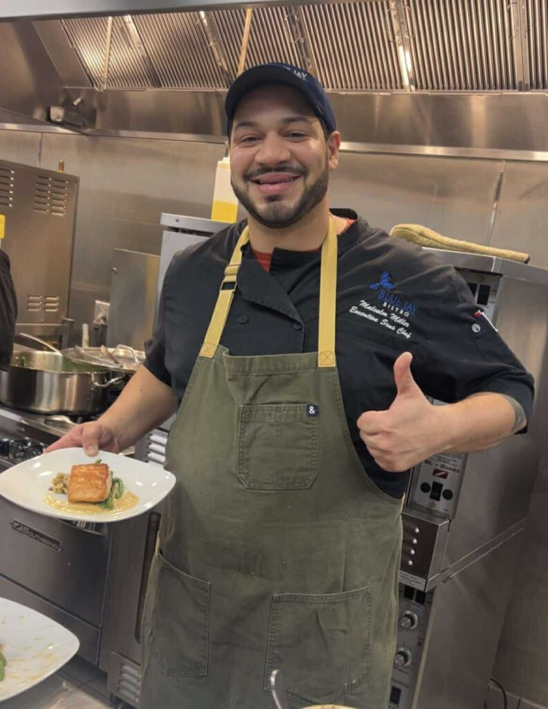 John 316 Center Taste Around the Lake 2025 chef holding up food and giving a thumbs up